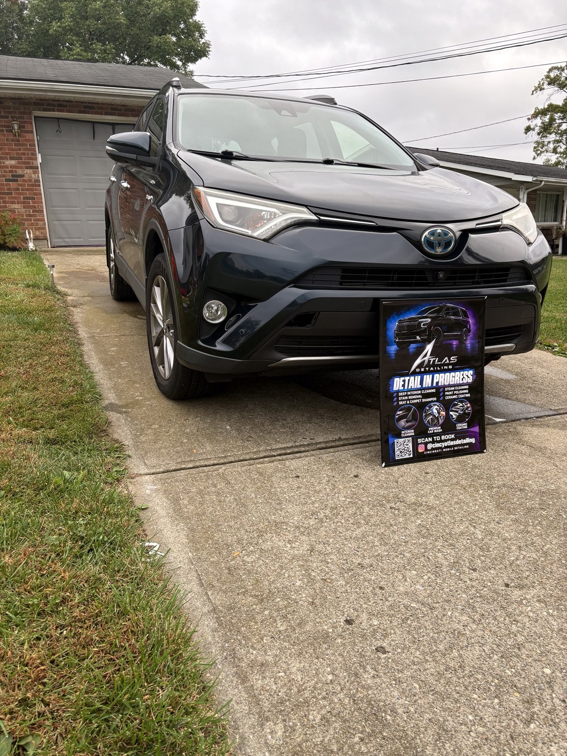 Toyota RAV4 parked in a driveway with an Atlas Detailing detail in progress sign